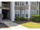 Exterior ground view of a building showcasing its architectural details, landscaping, and surrounding greenery at 1912 Parkside Village Dr, Clayton, NC 27520