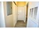 Neutral hallway showcasing wood-look flooring, doors, and an electrical panel at 1912 Parkside Village Dr, Clayton, NC 27520
