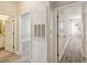 Hallway featuring doorways into other rooms, wood-look floors, and a neutral color scheme at 1912 Parkside Village Dr, Clayton, NC 27520