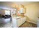 Bright, open kitchen with fresh paint, white cabinets, and a view into the living room at 1912 Parkside Village Dr, Clayton, NC 27520