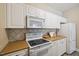 The kitchen has white cabinets, modern appliances, and lots of storage space at 1912 Parkside Village Dr, Clayton, NC 27520
