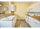 Bright kitchen featuring white cabinetry, laminate countertops, and stainless steel appliances at 1912 Parkside Village Dr, Clayton, NC 27520