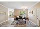 Cozy living room with neutral decor, wood-look floors, and a comfortable sofa at 1912 Parkside Village Dr, Clayton, NC 27520