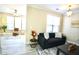 Cozy living room featuring a dark sofa with throw pillows, and bright natural light from the window at 1912 Parkside Village Dr, Clayton, NC 27520