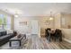 Charming living room and dining area with wood-look floors and neutral color scheme at 1912 Parkside Village Dr, Clayton, NC 27520