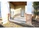 A cozy covered patio featuring two doors and brick pillars, perfect for outdoor relaxation at 1912 Parkside Village Dr, Clayton, NC 27520
