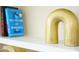 Close up of a white shelf that is decorated with books and a gold arched decoration at 1912 Parkside Village Dr, Clayton, NC 27520