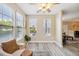 Bright sitting area with large windows, wood floors, and cozy armchair at 1912 Parkside Village Dr, Clayton, NC 27520