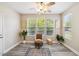 Bright sitting area featuring wood floors, natural light, and comfortable seating at 1912 Parkside Village Dr, Clayton, NC 27520