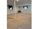 Open basement space with carpeting, white columns and paneled walls at 210 Crest Rd, Henderson, NC 27536