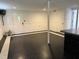 Spacious partially finished basement with black and white flooring at 210 Crest Rd, Henderson, NC 27536