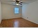 Minimalist bedroom with ceiling fan, neutral walls, and wood-look flooring at 210 Crest Rd, Henderson, NC 27536
