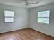 Bright, minimalist bedroom featuring hardwood floors, white walls, and plenty of natural light at 210 Crest Rd, Henderson, NC 27536