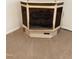 Corner fireplace with paneled wall and tan carpet at 210 Crest Rd, Henderson, NC 27536