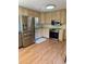 Bright kitchen features stainless steel appliances, light cabinetry, and hardwood floors at 210 Crest Rd, Henderson, NC 27536
