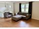 Bright living room with hardwood floors, gray sofas, and a window letting in natural light at 210 Crest Rd, Henderson, NC 27536