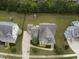 An aerial perspective reveals the expansive backyard with a playground, surrounded by lush greenery and neighboring homes at 212 Preatonwood Dr, Apex, NC 27539