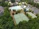 Wide aerial view of community amenities showcasing the pool area, tennis, and basketball courts surrounded by mature trees at 212 Preatonwood Dr, Apex, NC 27539