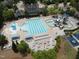High-definition aerial view of the community pool with its various water features, seating areas, and meticulous landscaping at 212 Preatonwood Dr, Apex, NC 27539