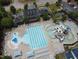 Aerial view of the community pool and clubhouse, featuring swimming areas, lounge chairs, and meticulously maintained landscaping at 212 Preatonwood Dr, Apex, NC 27539