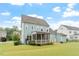 Backyard showcasing the house, a screened porch, a patio, and a lush lawn at 212 Preatonwood Dr, Apex, NC 27539