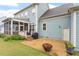 Backyard showcasing the house, a screened porch, a patio with a firepit, and a lush lawn at 212 Preatonwood Dr, Apex, NC 27539