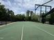 Full-sized basketball court for sports and recreation, surrounded by green landscaping and trees at 212 Preatonwood Dr, Apex, NC 27539