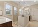 Modern bathroom featuring a frameless glass shower and double vanity with marble countertops at 212 Preatonwood Dr, Apex, NC 27539