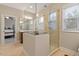 Bright bathroom with a glass-enclosed shower, double vanity, and a glimpse into the bedroom at 212 Preatonwood Dr, Apex, NC 27539