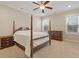 Four-poster bed in bedroom with beige walls and carpet, complemented by dark wood furnishings at 212 Preatonwood Dr, Apex, NC 27539