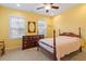 Comfortable bedroom with neutral carpet, natural light, and classic wood furnishings at 212 Preatonwood Dr, Apex, NC 27539