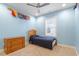 Cozy bedroom with hardwood floors, a twin bed, dresser, and nautical flag decorations at 212 Preatonwood Dr, Apex, NC 27539
