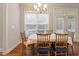Bright dining area with natural light, hardwood floors, and classic wooden furniture at 212 Preatonwood Dr, Apex, NC 27539