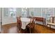 Dining room with hardwood flooring and neutral-toned wall, offering a refined dining experience at 212 Preatonwood Dr, Apex, NC 27539