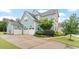Charming home featuring a spacious driveway leading to a three-car garage, complemented by manicured landscaping at 212 Preatonwood Dr, Apex, NC 27539