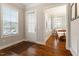 Welcoming foyer with hardwood floors, a view into the dining area, and natural light streaming through windows at 212 Preatonwood Dr, Apex, NC 27539