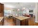 Open kitchen layout with granite island, stainless steel appliances, and a seamless flow to the living spaces at 212 Preatonwood Dr, Apex, NC 27539