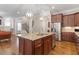 Modern kitchen with granite island, stainless appliances, and seamless transition to living spaces at 212 Preatonwood Dr, Apex, NC 27539