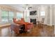 Cozy living room features a fireplace, hardwood floors, and windows overlooking the outdoors, creating a warm ambiance at 212 Preatonwood Dr, Apex, NC 27539
