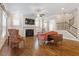 Inviting living room with a fireplace, hardwood floors, and staircase, perfect for relaxing and entertaining guests at 212 Preatonwood Dr, Apex, NC 27539