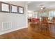 Bright and spacious living room featuring hardwood floors, a ceiling fan, and seamless flow into the dining area at 212 Preatonwood Dr, Apex, NC 27539