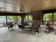 Inviting outdoor seating area with tables, chairs, and a cozy fireplace for relaxed gatherings at 212 Preatonwood Dr, Apex, NC 27539