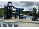 Community pool featuring a thrilling spiral water slide and ample seating, ideal for Gathering enjoyment at 212 Preatonwood Dr, Apex, NC 27539