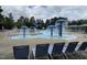 Community pool area with a splash fountain, water slide and ample seating for relaxation at 212 Preatonwood Dr, Apex, NC 27539