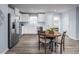 Bright kitchen with white cabinets, stainless steel appliances, and a round wooden dining table at 220 Gianna Dr, Lillington, NC 27546