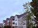 Multi-Gathering apartment building featuring brick and vinyl siding, balconies, and dark roofing at 2221 Delaney Dr # 112, Burlington, NC 27215