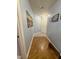 Hallway featuring wood flooring and blue walls, with art decorations at 2221 Delaney Dr # 112, Burlington, NC 27215