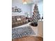 Cozy living room featuring a large sofa, decorative rug and a beautifully decorated Christmas tree at 2221 Delaney Dr # 112, Burlington, NC 27215