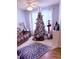 Cozy living room with a large Christmas tree, comfortable seating, and soft natural light at 2221 Delaney Dr # 112, Burlington, NC 27215