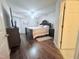 Spacious primary bedroom featuring a ceiling fan, hardwood floors, and a king bed at 2221 Delaney Dr # 112, Burlington, NC 27215